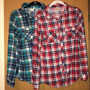 Two long sleeve button up flannel shirts